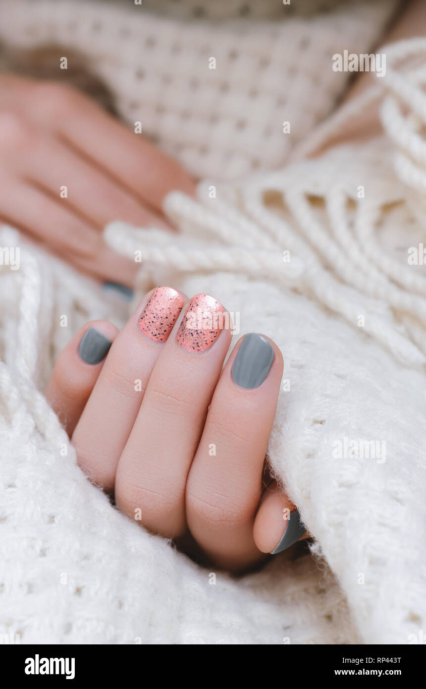 Female hand with pink and gray nail design Stock Photo - Alamy
