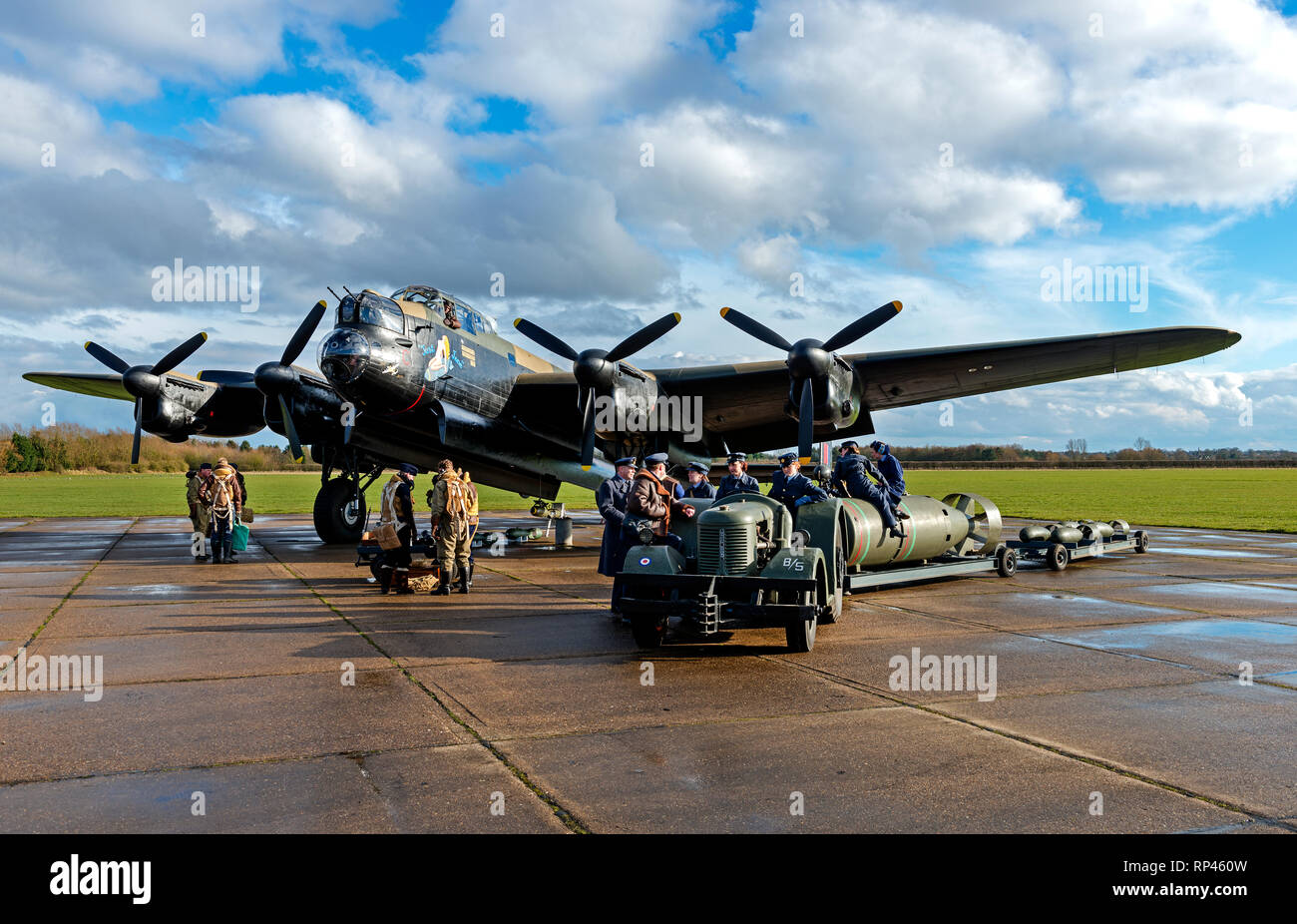 Avro Lancaster bomber Just Jane NX611 with Second World War reenactors loading bombs at East Kirkby, Lincolnshire UK - 16/3/2013 Stock Photo