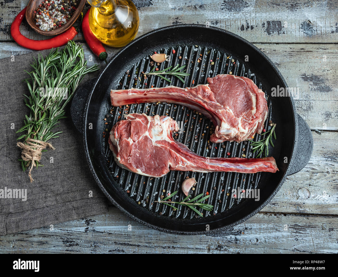 Raw meat lamb veal ribs loin on the grill pan, spices , chops ready for cooking Stock Photo