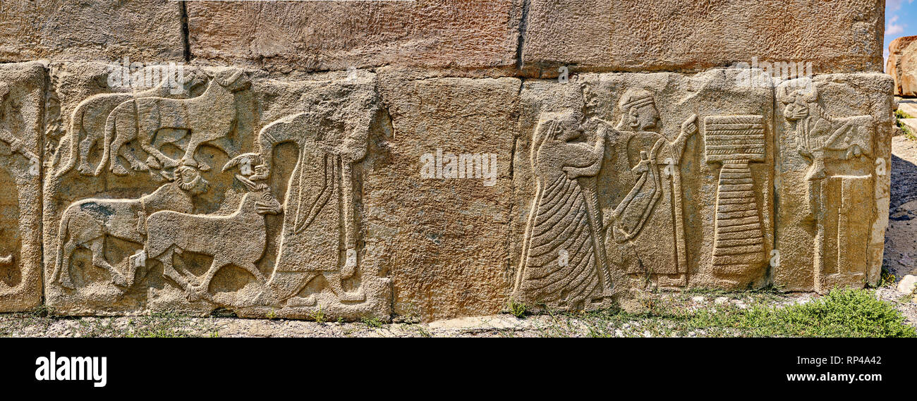 Pictures & Images Hittite relief sculpted orthostat panels of the Sphinx Gate. Left panel depicts a man leading goats to be sacrificed (right) a king  Stock Photo
