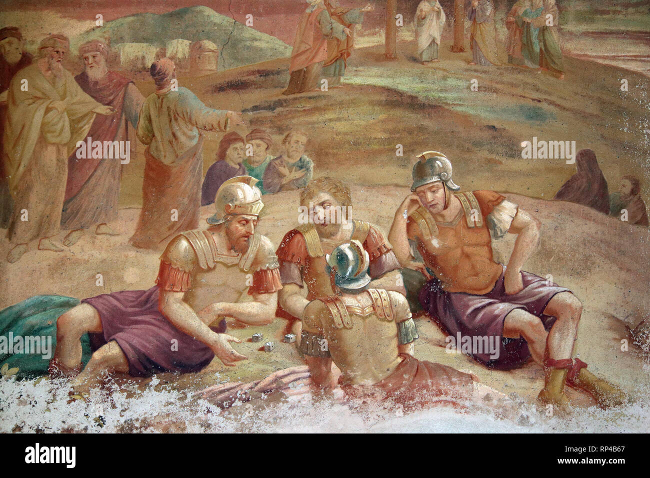Roman soldiers playing dice about things of Jesus Christ - old mural painting Stock Photo