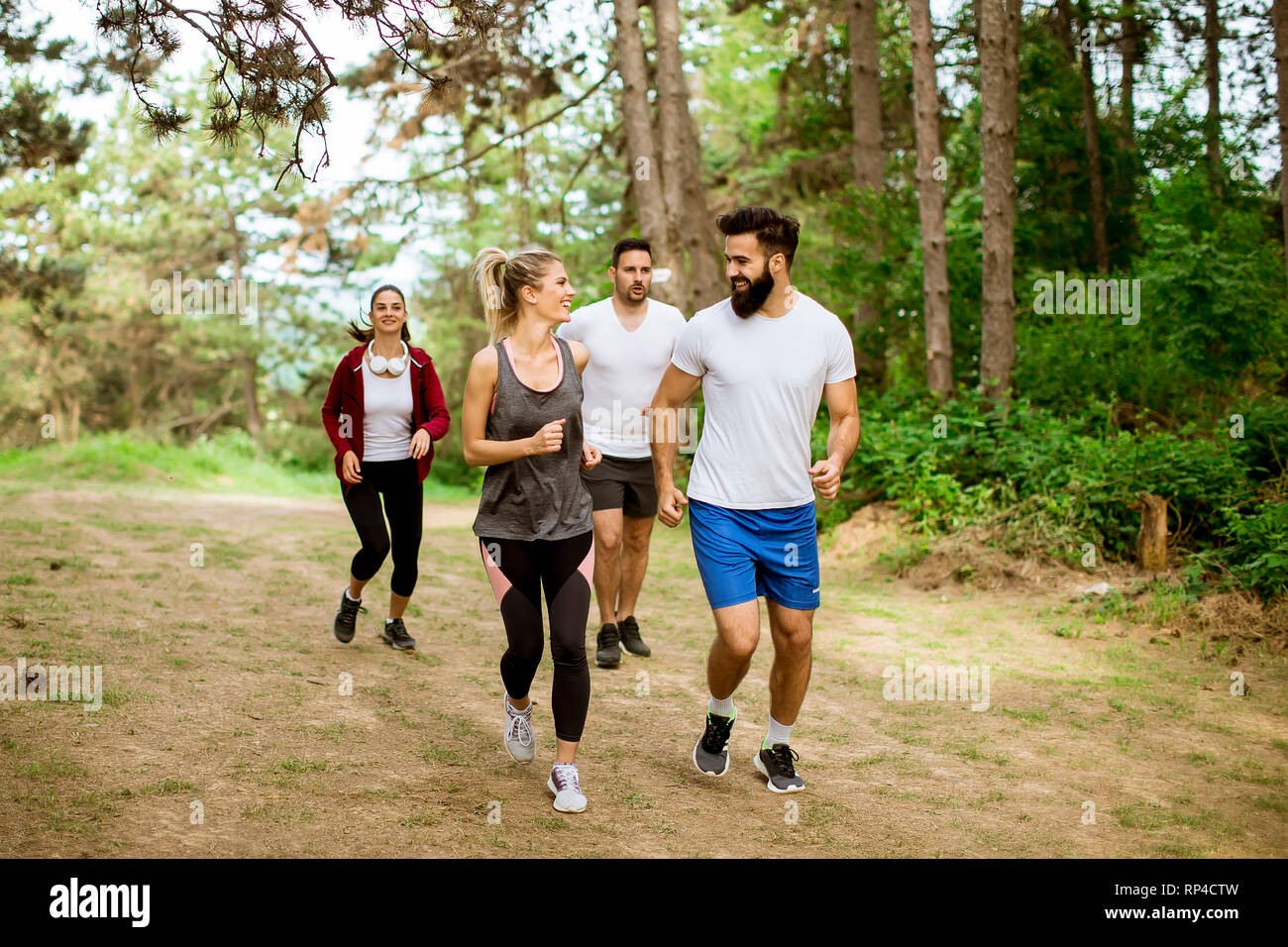 Young people run a marathon through the forest Stock Photo - Alamy