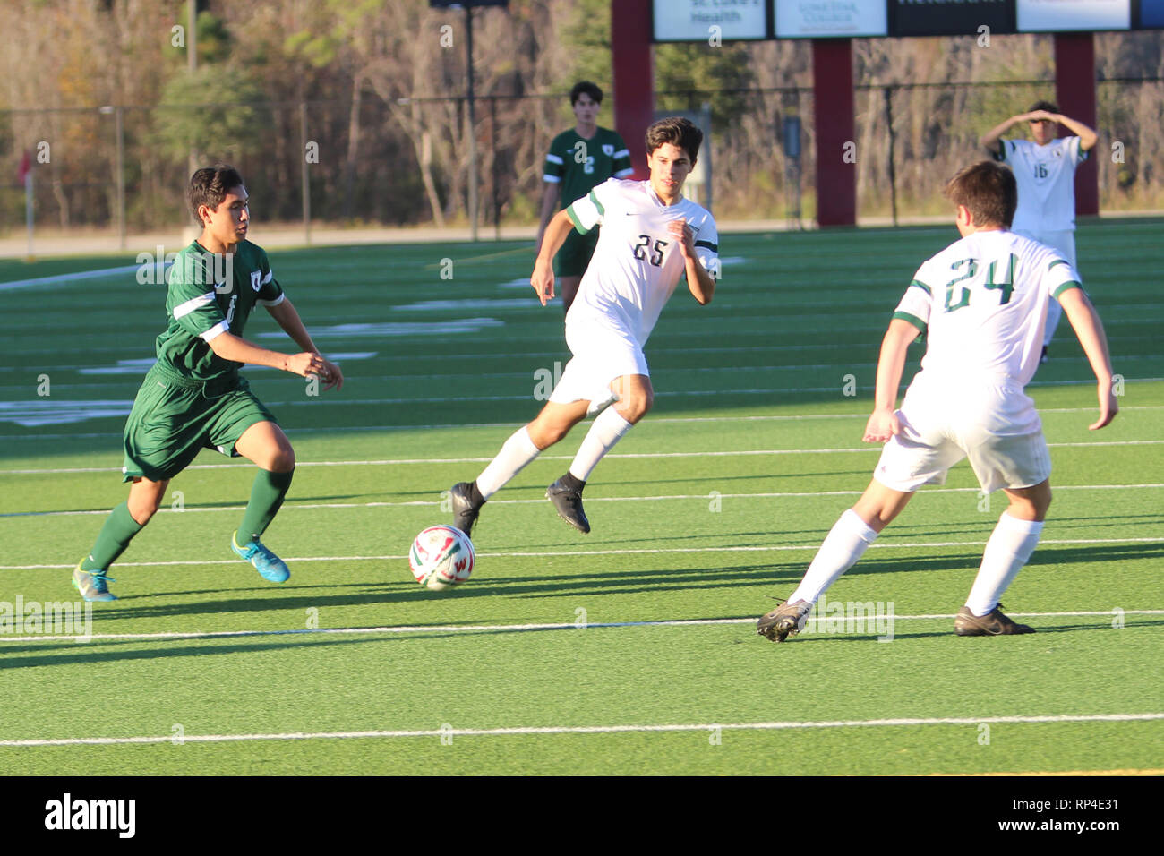 Player dribbles the ball in the midfield with defenders close by during