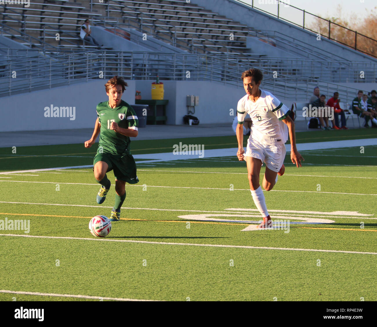 Player dribbles down the wing with a defender marking him during a boys