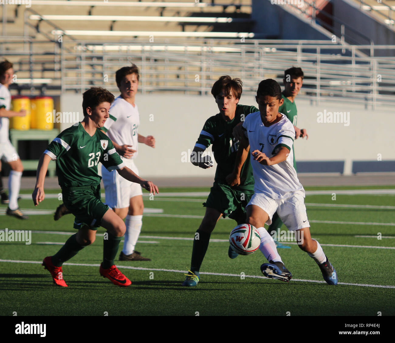 All eyes are on the soccer ball during a boys high school soccer game