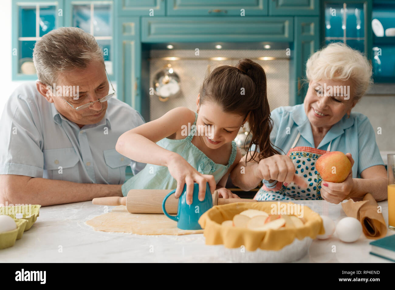 Happy Girl Making A Pie Stock Photo - Alamy