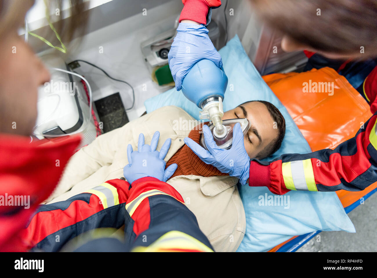 Paramedics doing cardiopulmonary resuscitation in ambulance car Stock Photo