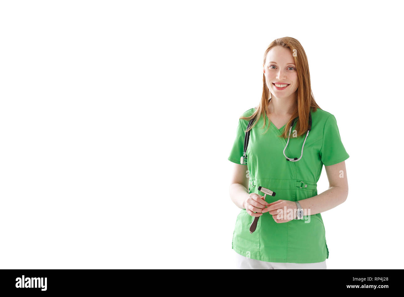 Portrait of smiling woman doctor with stethoscope and hammer in green medical gown isolated on white background. Stock Photo