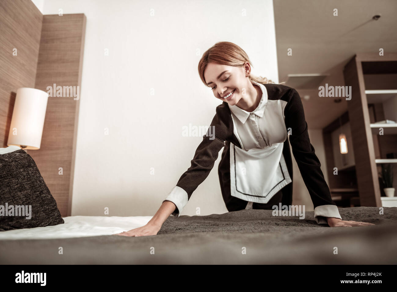 Young housekeeper feeling nice having her first working day Stock Photo