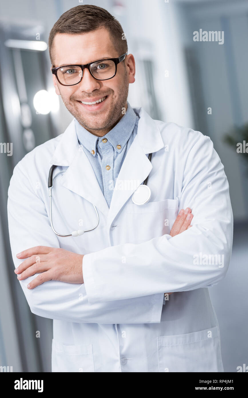 Happy young doctor crossed arms hi-res stock photography and images - Alamy