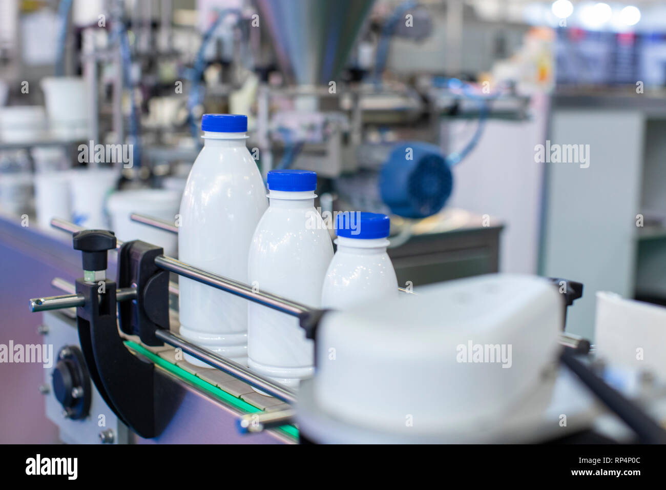 Factory line for bottling milk or yogurt Stock Photo Alamy