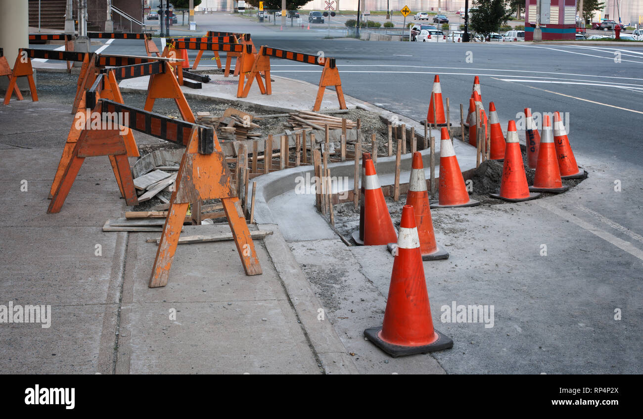 Traffic cones and barriers surrounding street construction site Stock