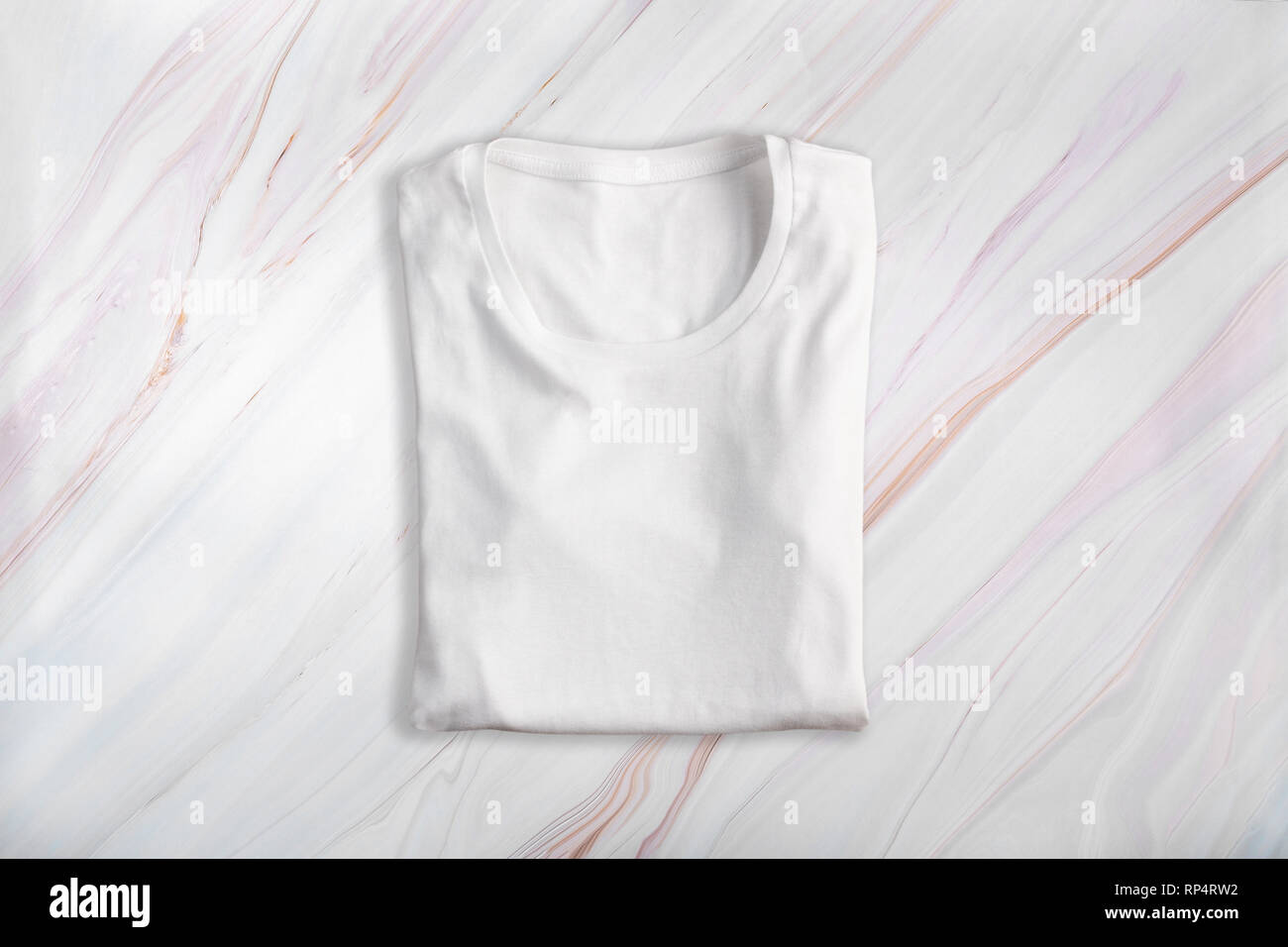 White blank folded t-shirt on marble background Stock Photo