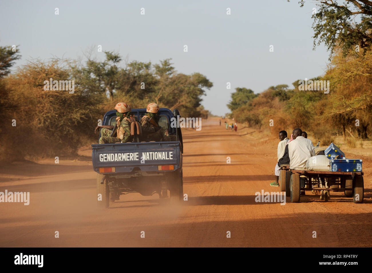 BURKINA FASO Dori, growing islamist terror in this region, this region is declared as red zone in connection with terrorist attacks and insecurity, armed police patrol on road to Goudebo refugee camp at border to Mali Stock Photo