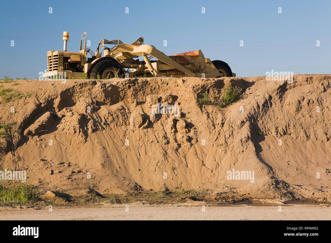 Loader on top of a mound of sand in a commercial sandpit Stock Photo