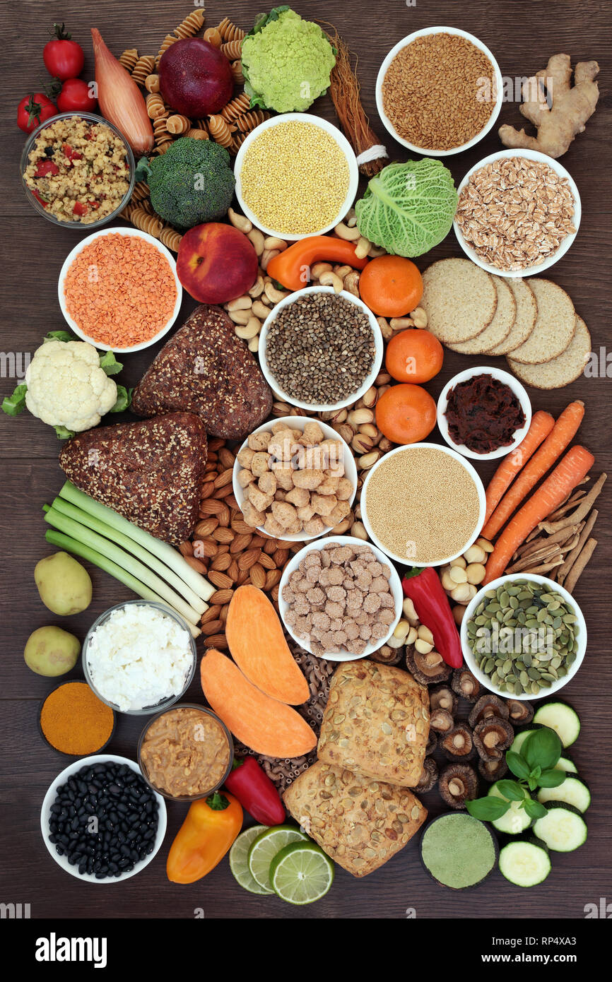 Vegan health food with seeds, nuts, sos mix, fruit, vegetables, wholegrain bread rolls, cereals