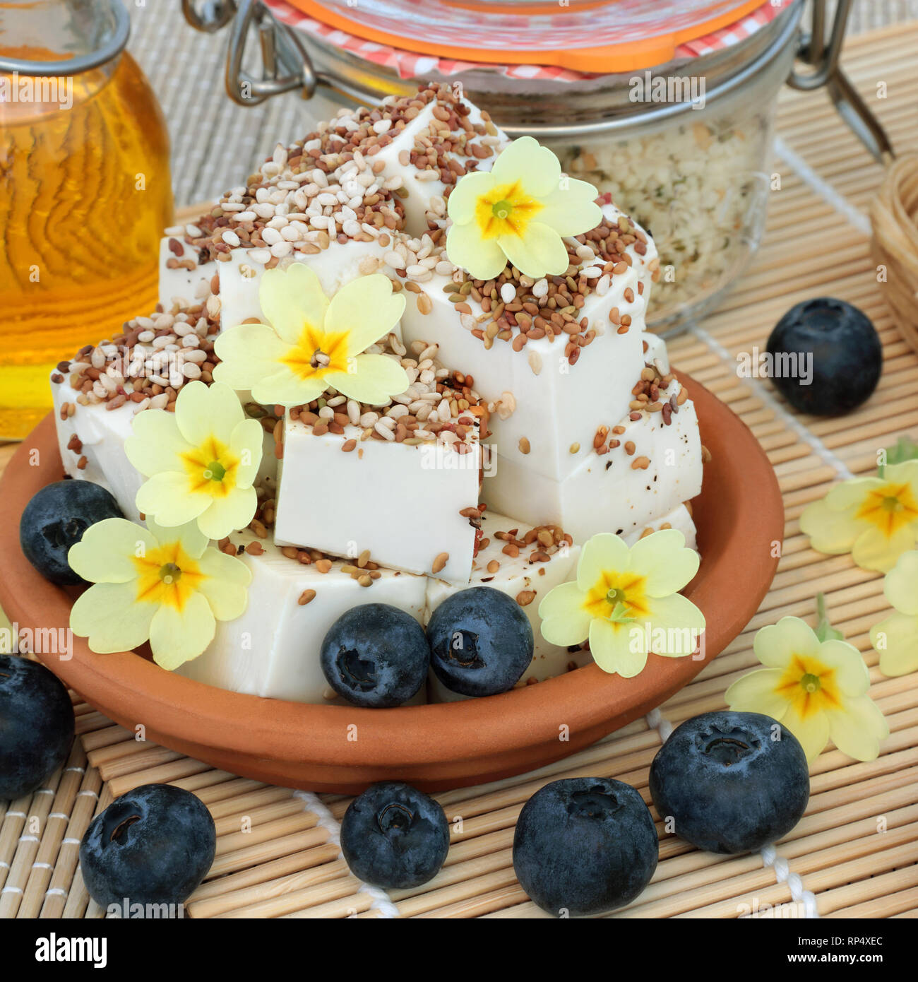 Vegan health food with tofu bean curd dusted with alfalfa and sesame seed & ground pepper