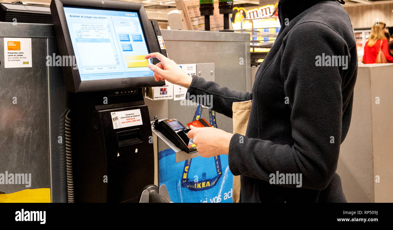 PARIS, - SEP 2, 2017: Young woman paying at the sef-service inthe IKEA furniture store the touchscreen display Stock Photo - Alamy