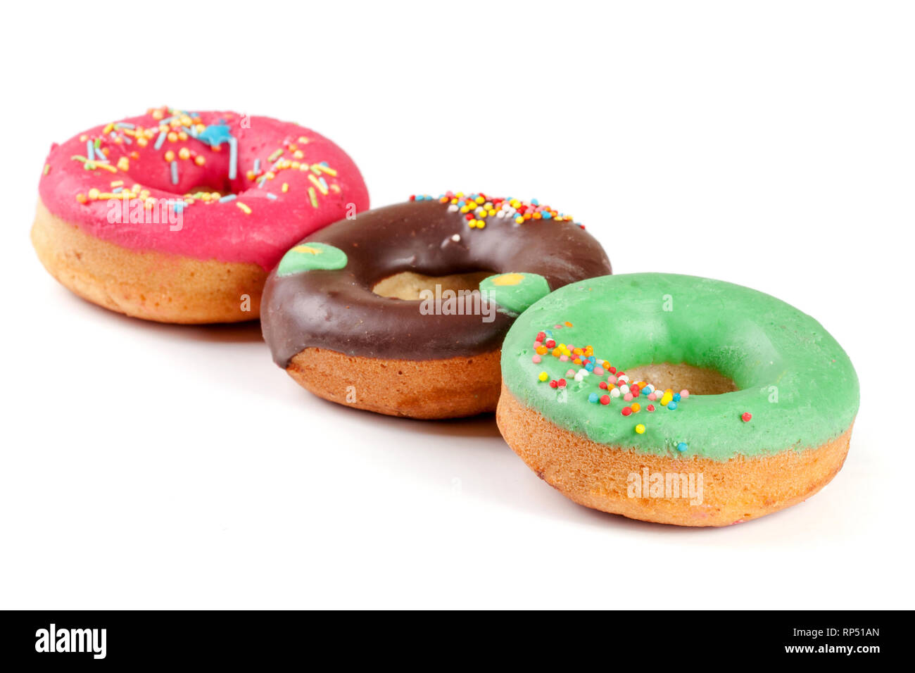 three glazed donut isolated on white background Stock Photo - Alamy
