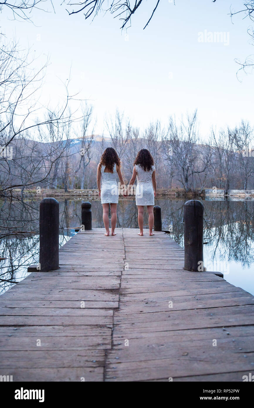 Twin sisters holding hands hi-res stock photography and images - Alamy