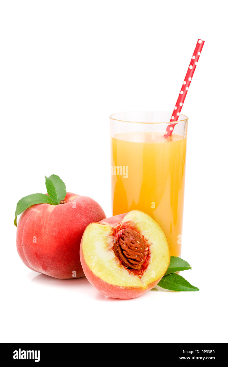 Glass of fruit juice with straw and cut peaches isolated on white