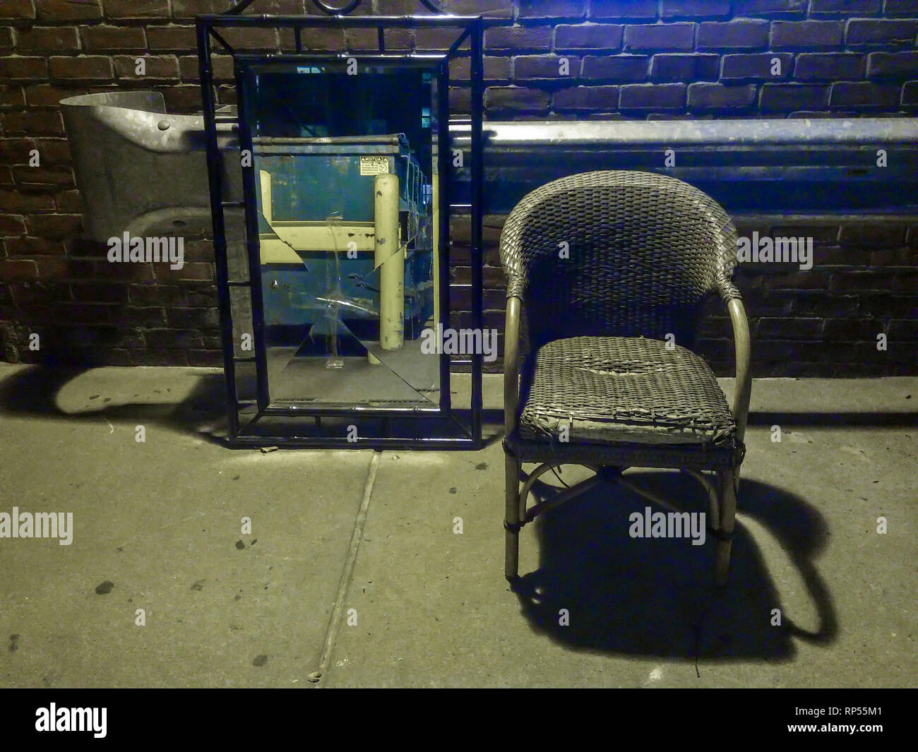 A discarded chair and broken mirror await pick-up by the New York City Dept. of Sanitation on Friday, February 15, 2019. (© Richard B. Levine) Stock Photo