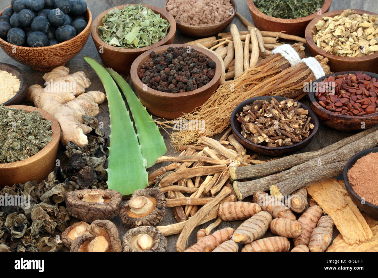 Adaptogen food selection with herbs, spice, fruit and supplement powders. Used in herbal medicine to help the body resist the effects of stress. Stock Photo