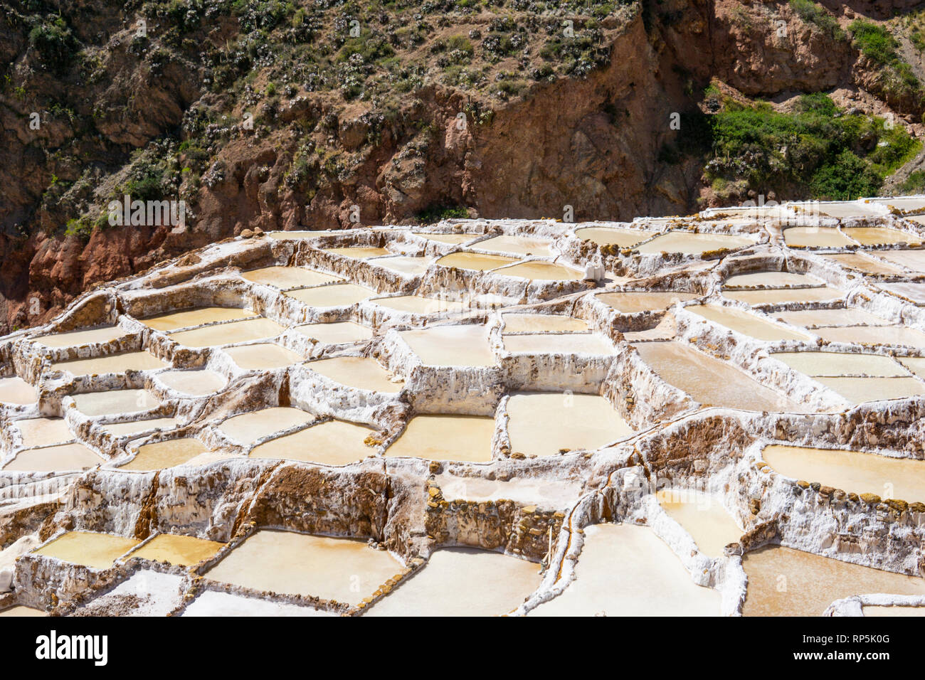 Maras salt mines on the hillside in the mountainous Cuzco region of Peru. Stock Photo