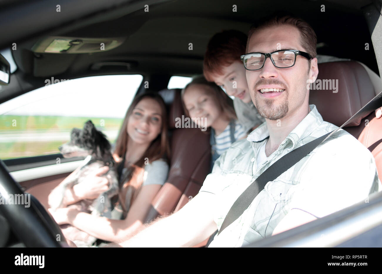 side view.happy father driving a family car Stock Photo - Alamy