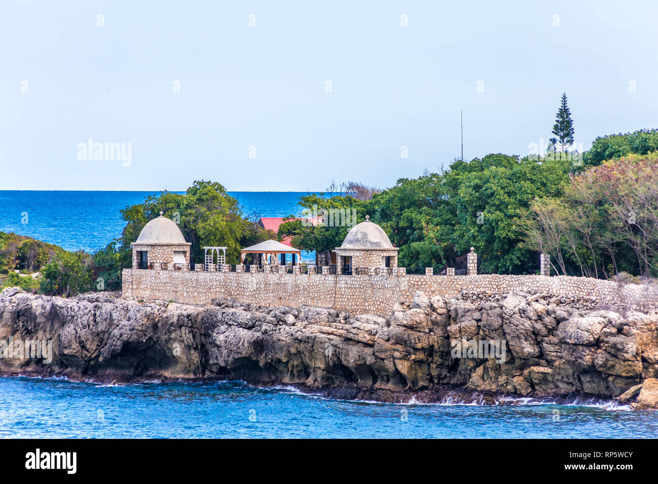 A stone wall and observation points over the sea on the coast of Haiti Stock Photo