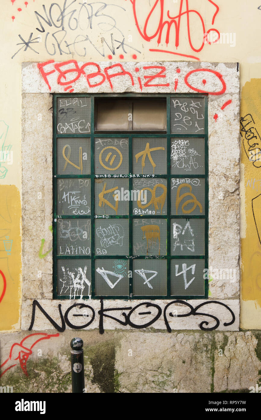 Window covered with graffiti in Alfama district in Lisbon, Portugal. Stock Photo