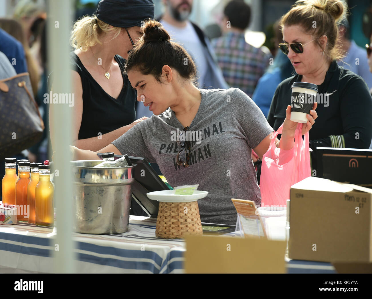 America Ferrera samples Kombucha drinks and peruses the produce at the