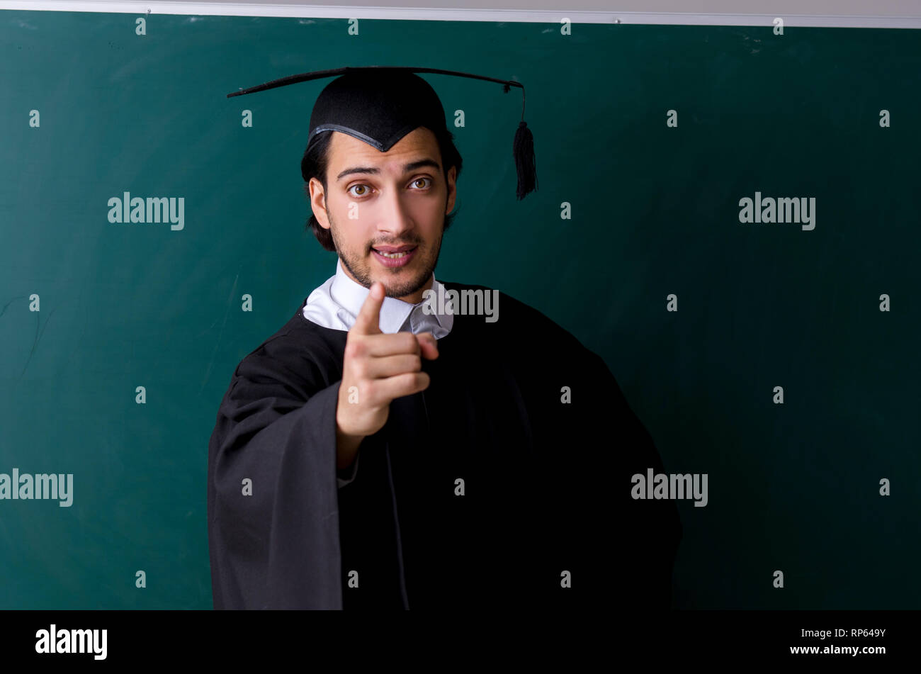 Graduate Board Students Graduate student in front of green board Stock Photo - Alamy