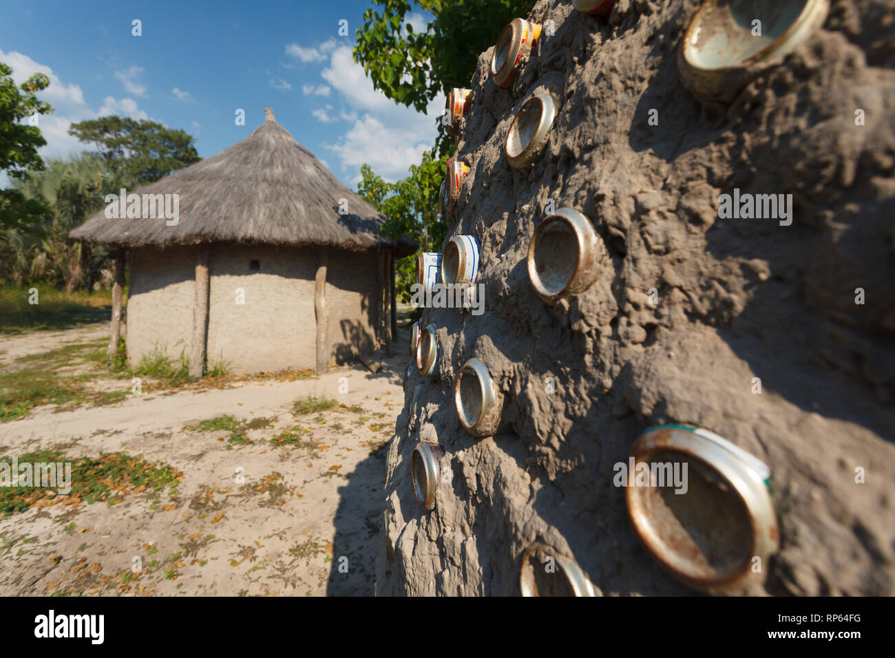 Closeup of traditional mud hut of natives of Botswana, Africa. One has smashed aluminum cans pushed into mud for decoration Stock Photo