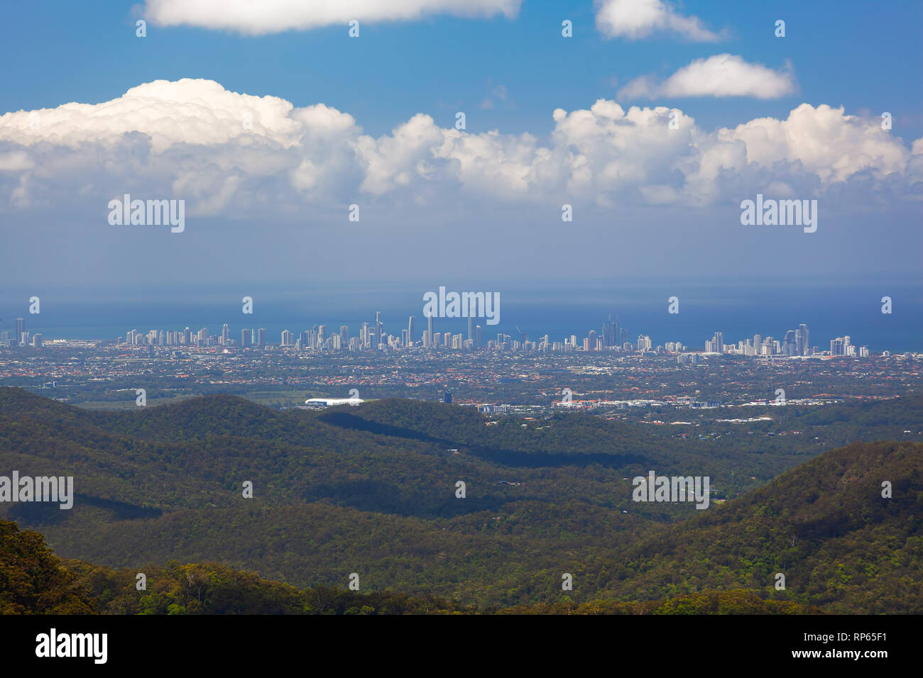 Beautiful green hills with Gold Coast skyscrapers in the distance on bright summer day. Queensland, Australia Stock Photo