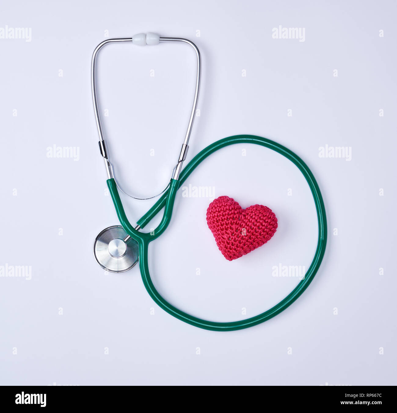 green medical stethoscope and red heart on white background Stock Photo ...