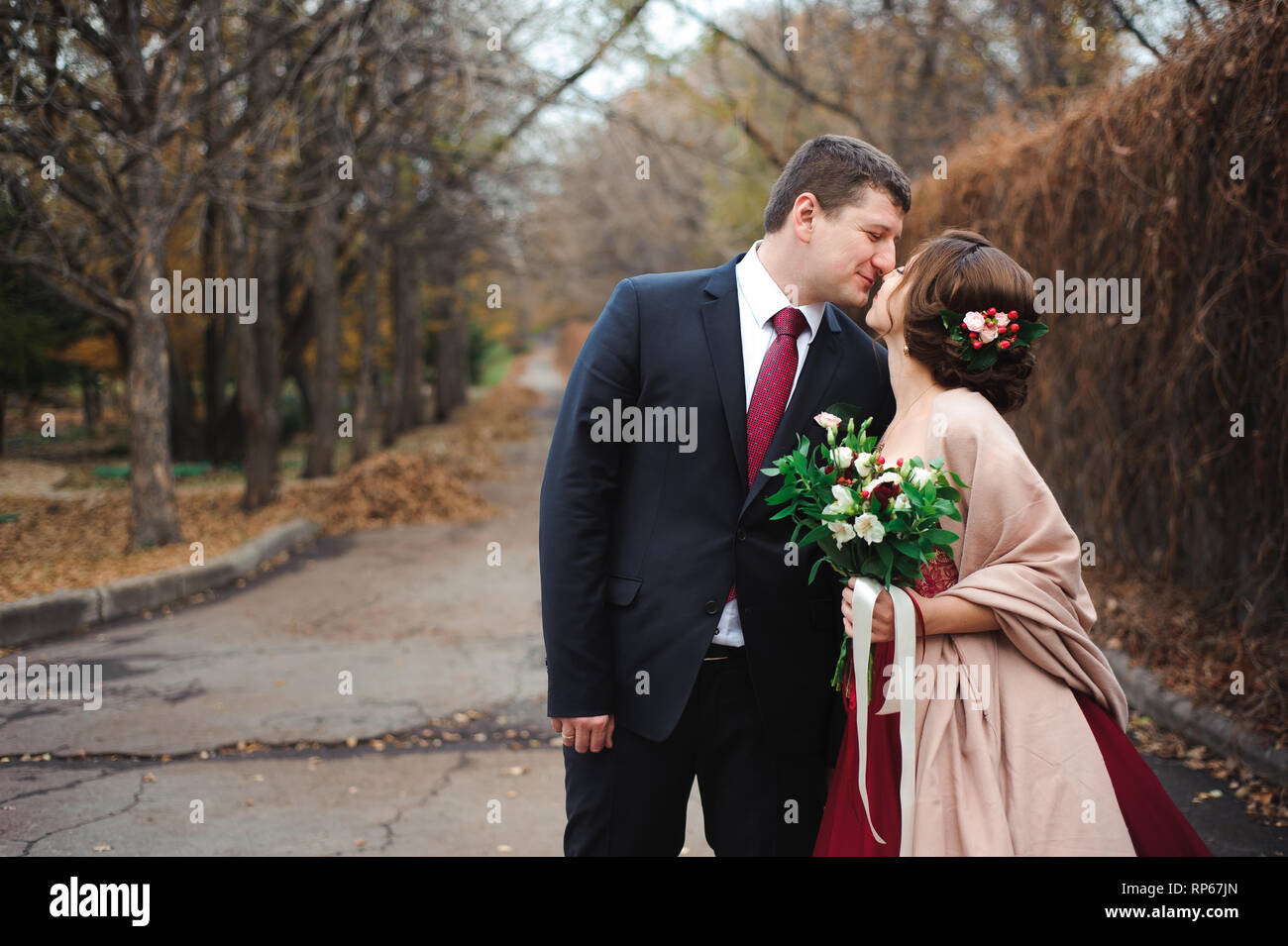 Bride and groom hugging in a forest in the autumn forest Stock Photo ...