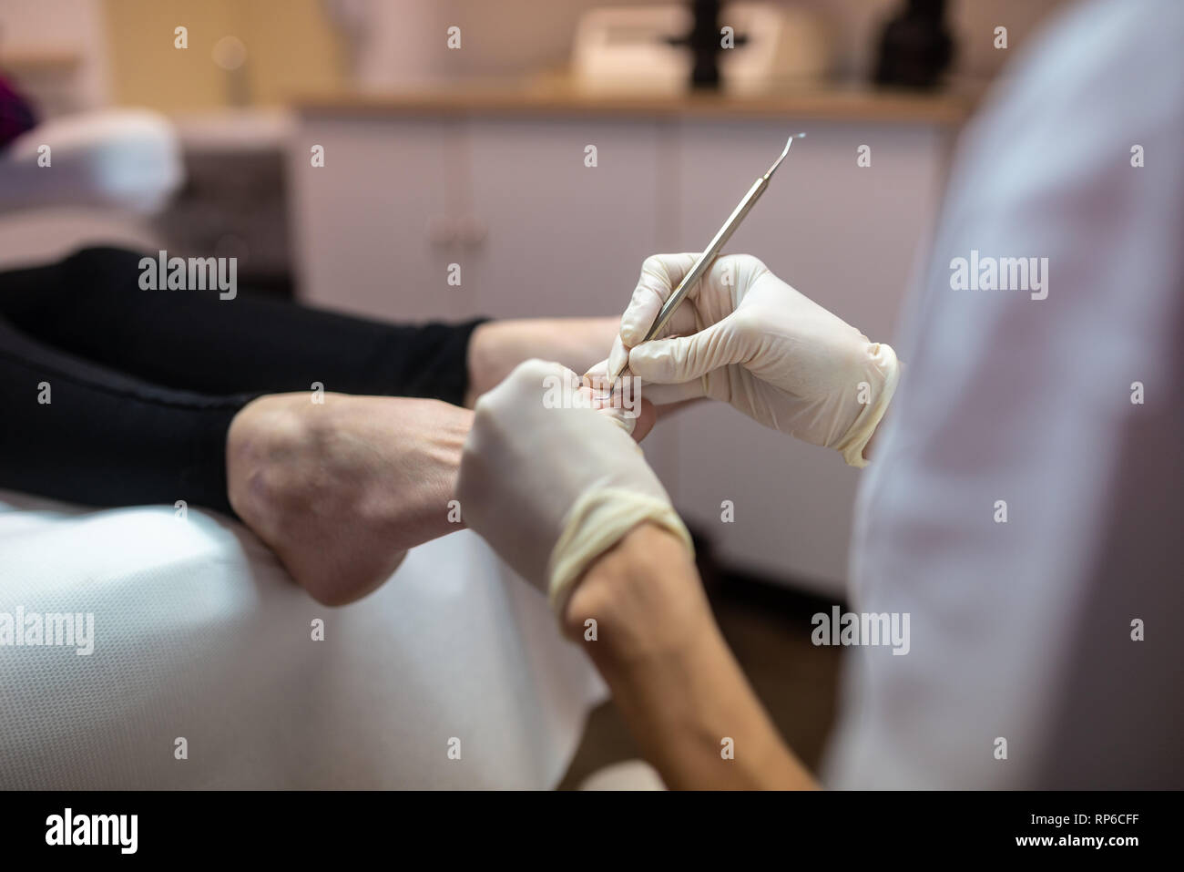 Closeup of removing cuticle from toenails in a pedicure treatment Stock