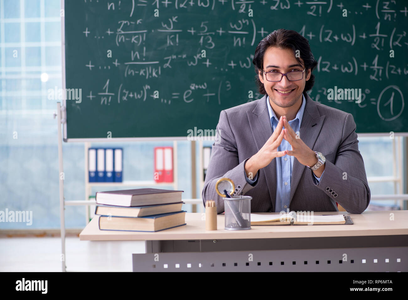 Young handsome math teacher in classroom Stock Photo