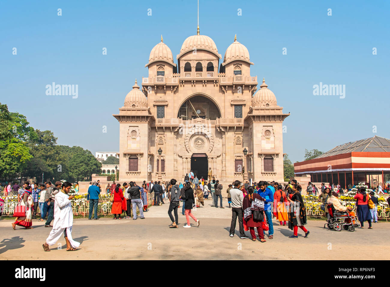 The Belur Math church in Kolkata with tourists and local people walking around and visiting on a sunny day with blue sky. Stock Photo