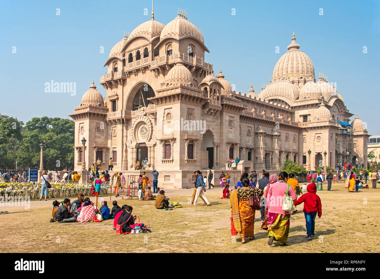 The Belur Math church in Kolkata with tourists and local people walking around and visiting on a sunny day with blue sky. Stock Photo