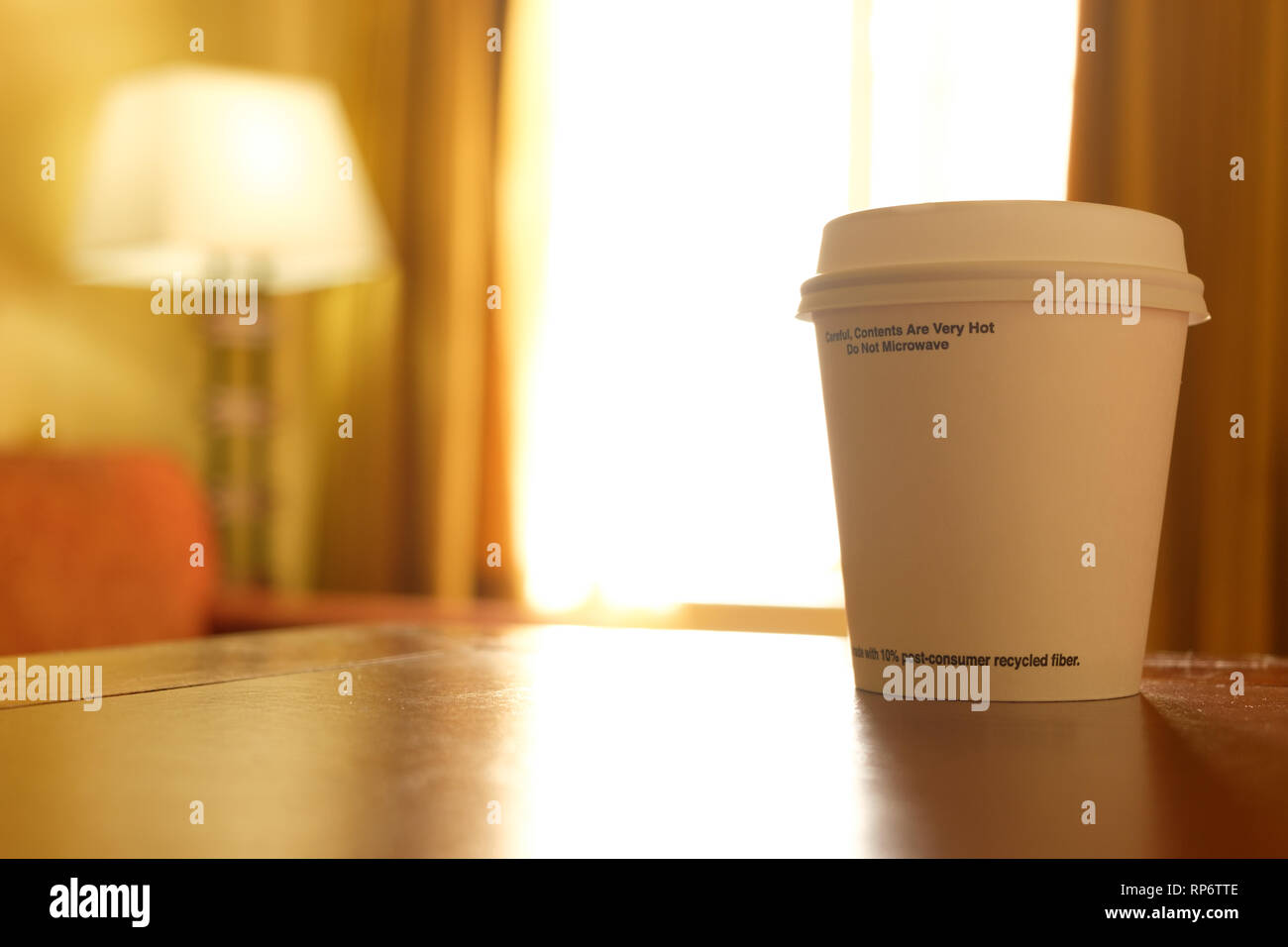 Cup of coffee to go at early morning in hotel room Stock Photo