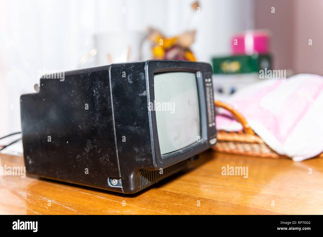 Closeup of tiny small one black television retro vintage in dacha cottage home on wooden table in country countryside living room Stock Photo