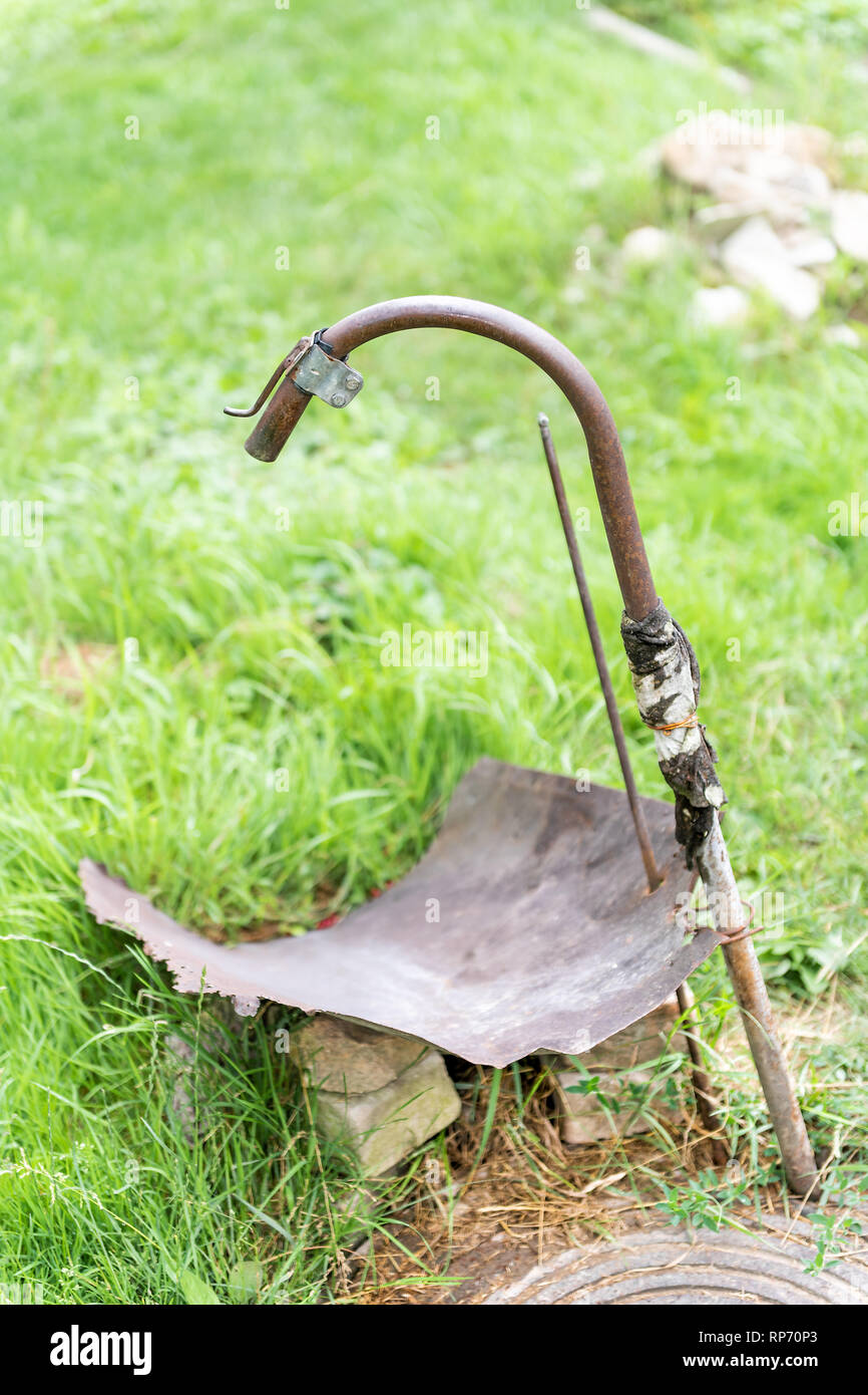 Vertical closeup of retro diy rustic well in garden in green summer in Ukraine or Russia dacha with faucet Stock Photo