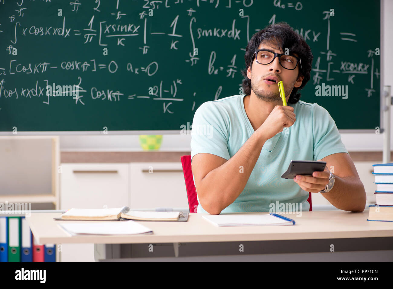 Young male student mathematician in front of chalkboard Stock Photo - Alamy