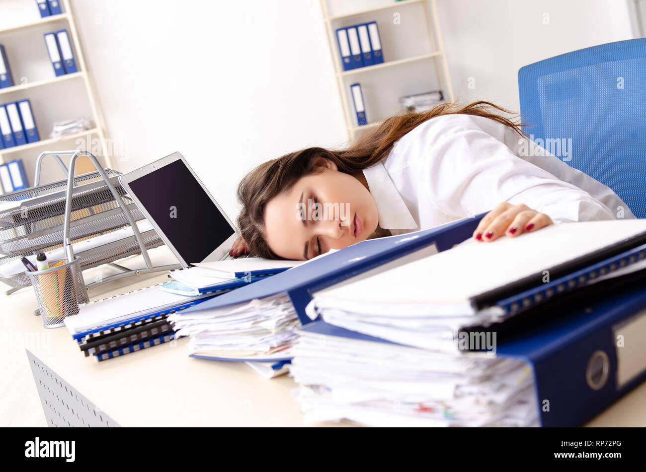 Young female employee unhappy with excessive work Stock Photo