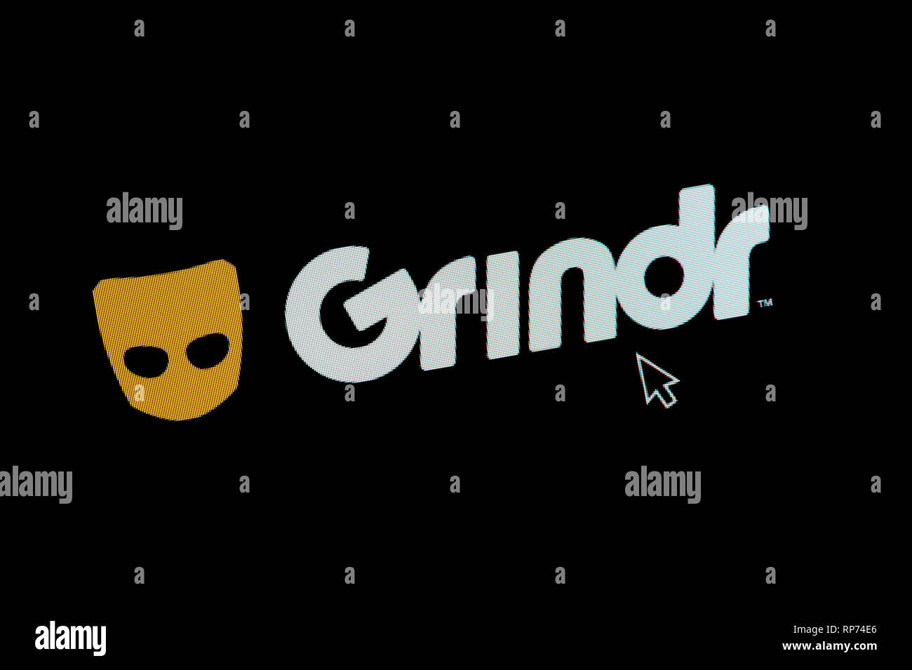 The logo of Grindr is seen on a computer screen along with a mouse cursor (Editorial use only) Stock Photo