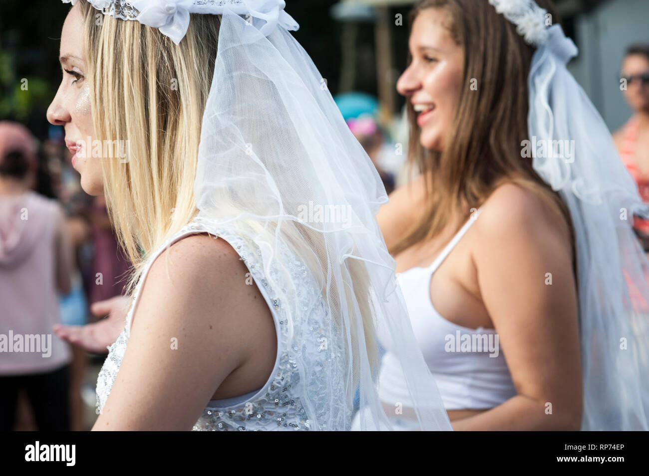 RIO DE JANEIRO - FEBRUARY 11, 2017: Young Brazilian women celebrate Carnival in bridal costumes at an afternoon street party in Ipanema. Stock Photo