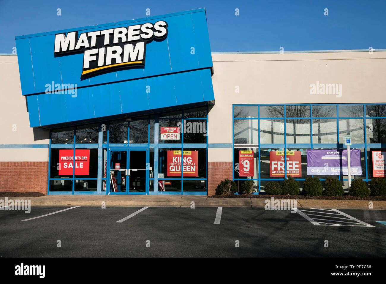 A logo sign outside of a Mattress Firm retail store location in