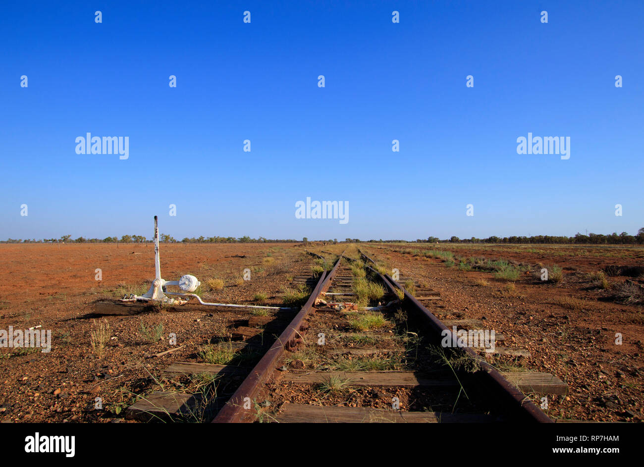 Old outback Australian railway tracks in western Queensland with blue